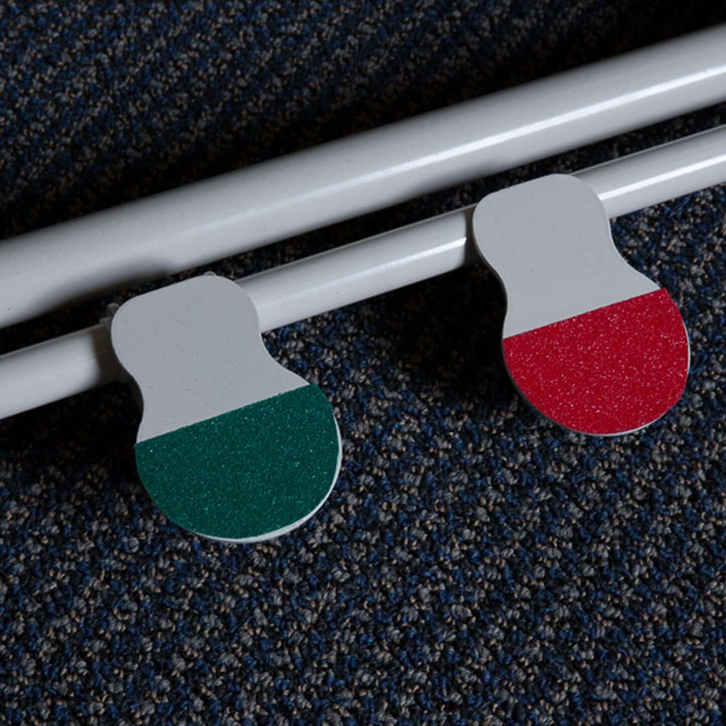 Green and red decorative elements resembling Italy's flag on a white surface.