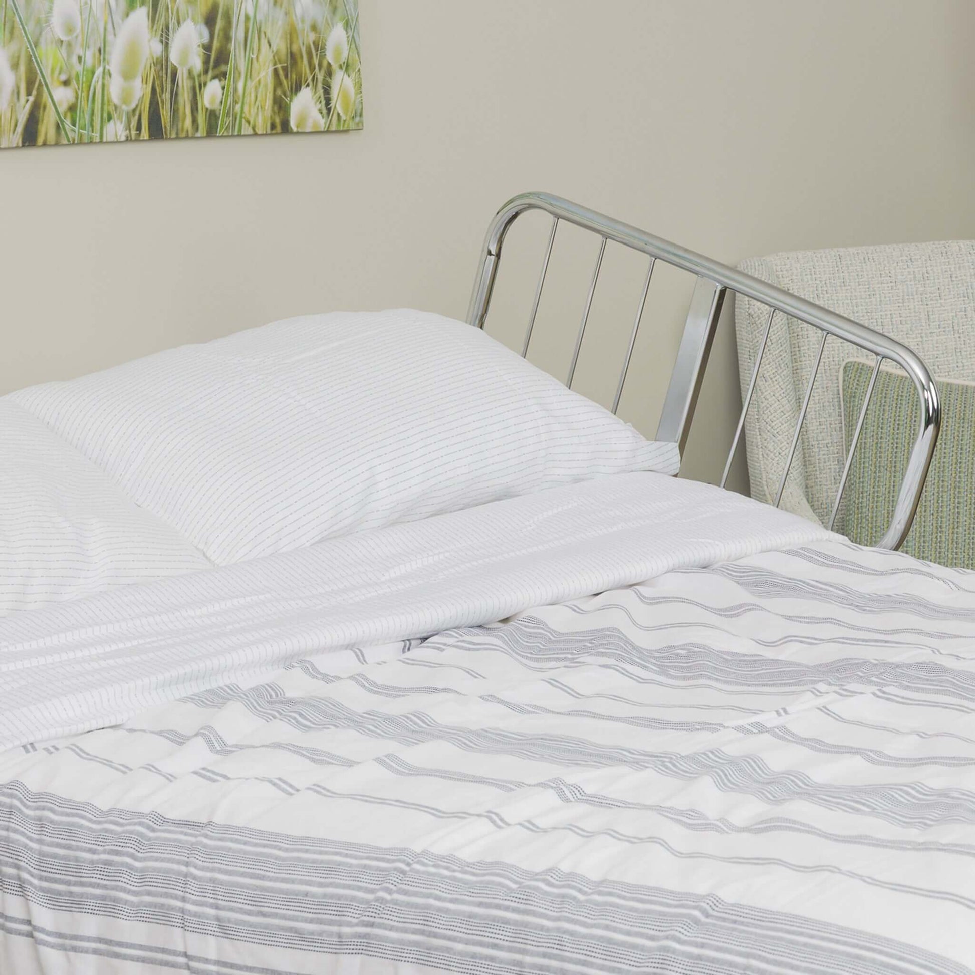 Transfer Master Supernal 5 Hi-Low Adjustable Bed with linens, showcasing a comfortable hospital bed for homecare use.