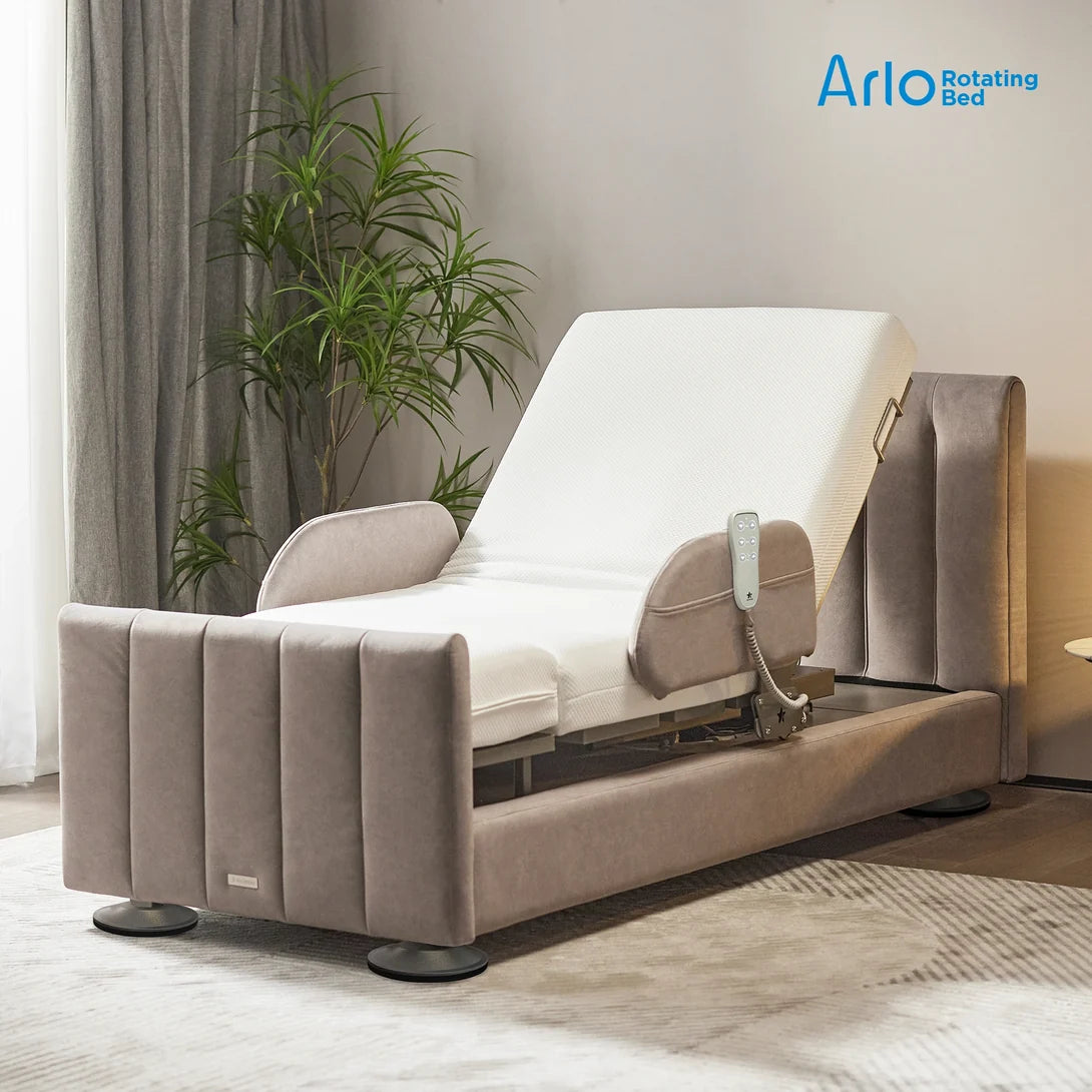 Arlo rotating hospital bed with upholstered frame in a home bedroom